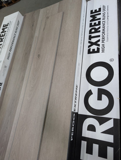 Light neutral wood-look Pergo vinyl planks displayed on a Pergo Extreme sample board